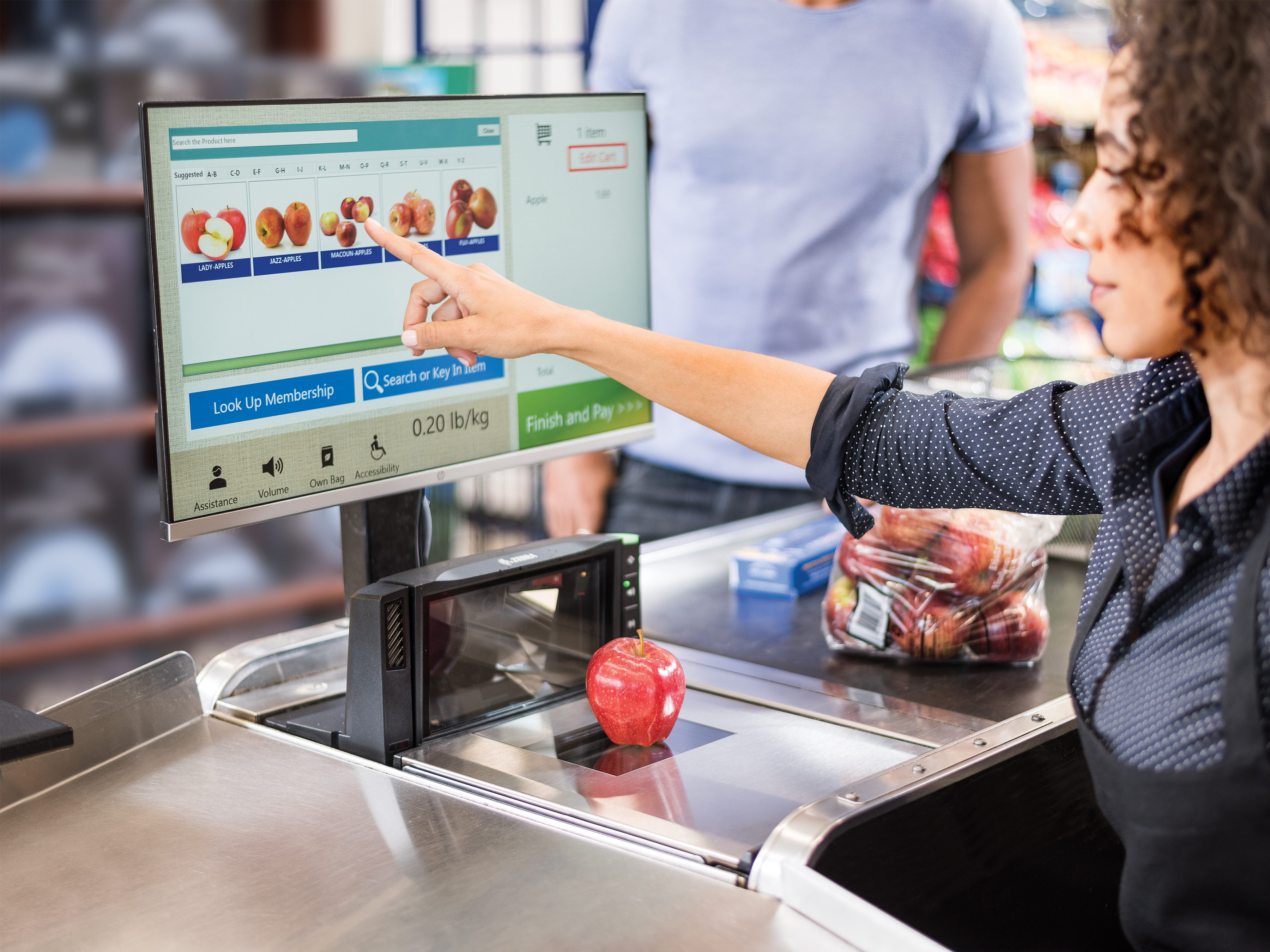 Cashier using a Zebra grocery scanner with single plane and multi-plane scanning technology