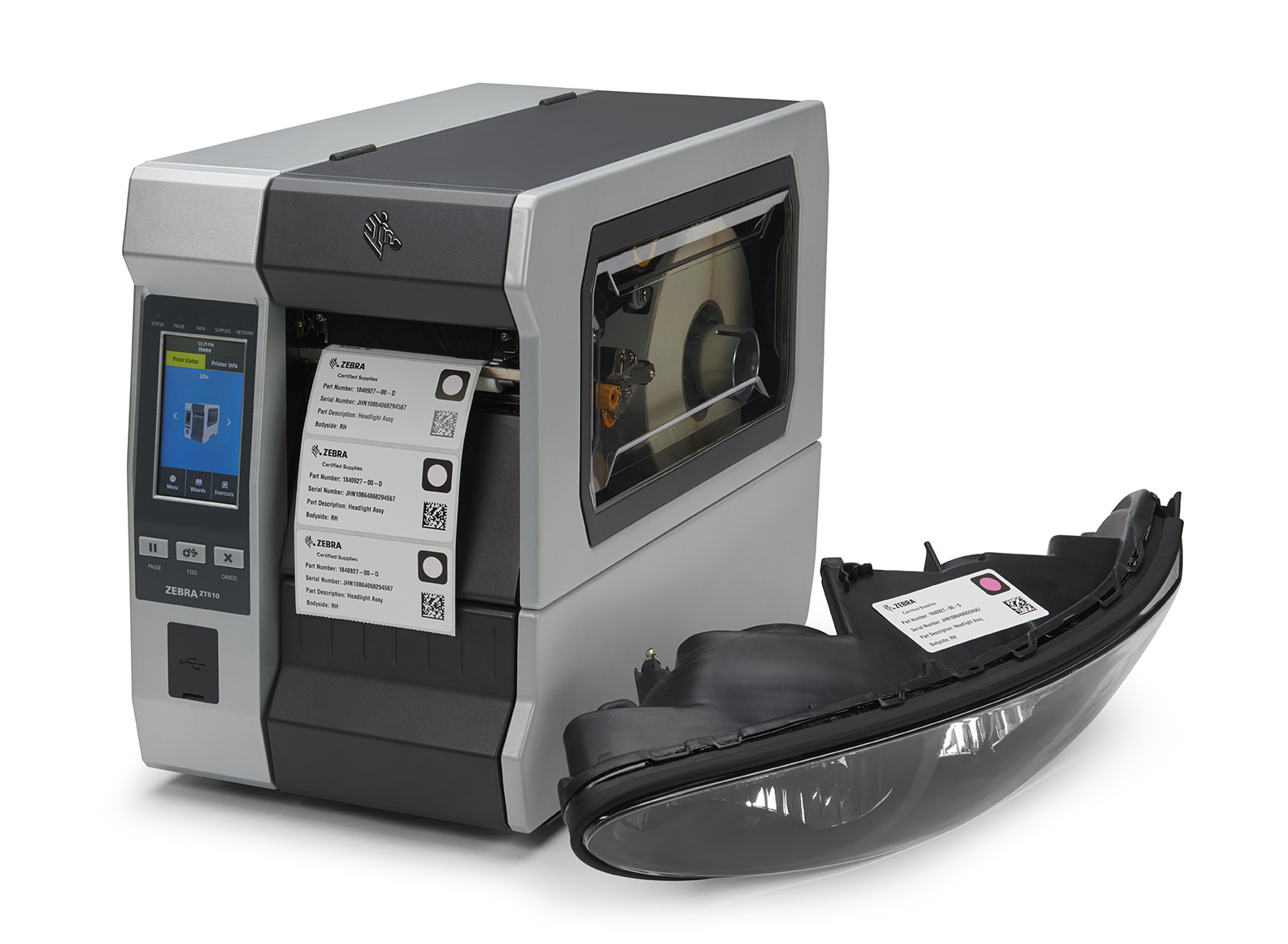 ZeOn-Demand printable environmental indicators on thermal labels being printed by a Zebra industrial printer. Next to this thermal printer, a product showcasing the use of one of these printed sensors adhered firmly on top, displaying a red color revealing that the product has successfully gone through a heat treatment process as part of a manufacturing workflow.